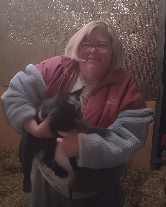 Woman holding a baby goat